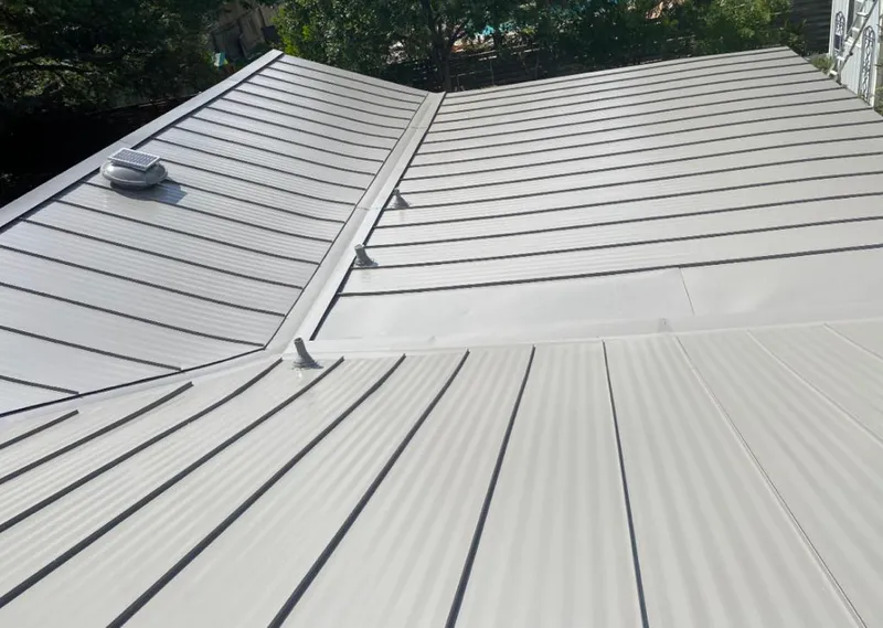 Solar attic fan installed on a metal roof for Roof Ventilation in Homeland